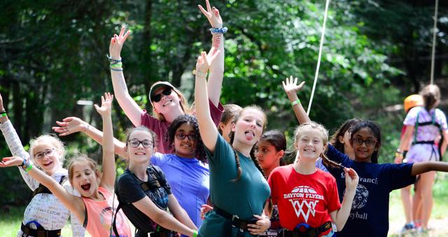 Summer camp counselors posing with campers