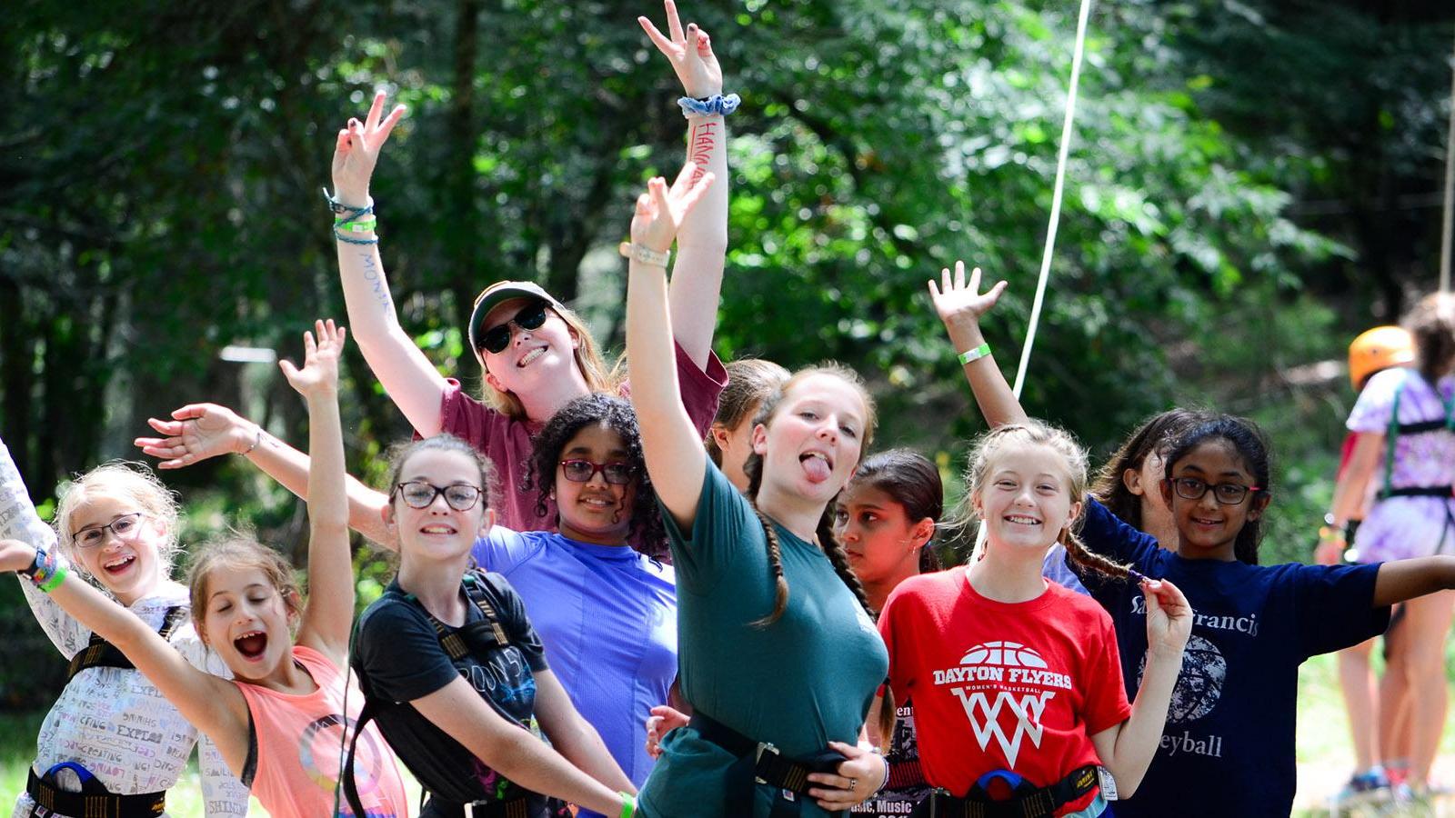 Summer camp counselors posing with campers